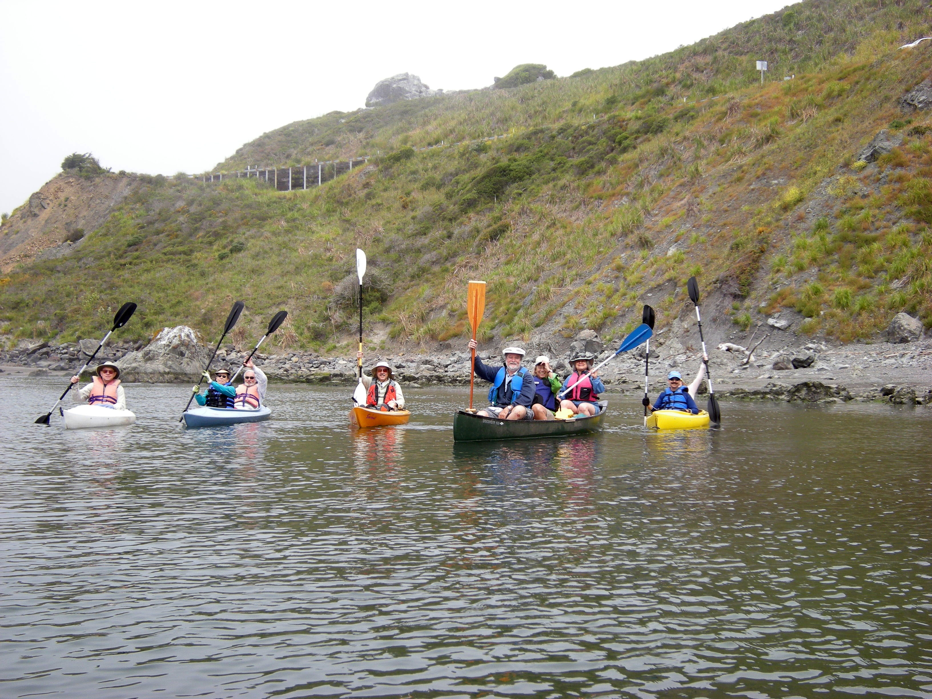 A group of people kayaking on a body of water