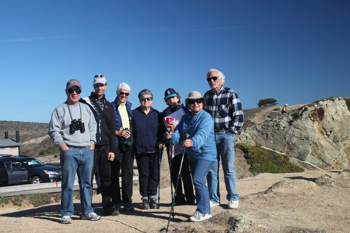 A group of hikers with blue skies in the background